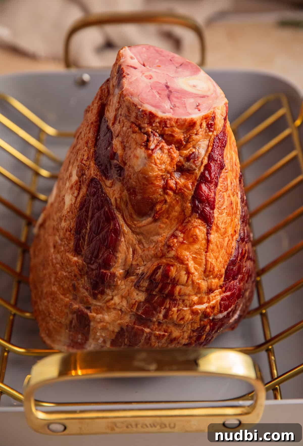 Apricot-Glazed Ham Recipe for Holidays and Entertaining 5 Spiral ham on roasting rack in roasting pan.