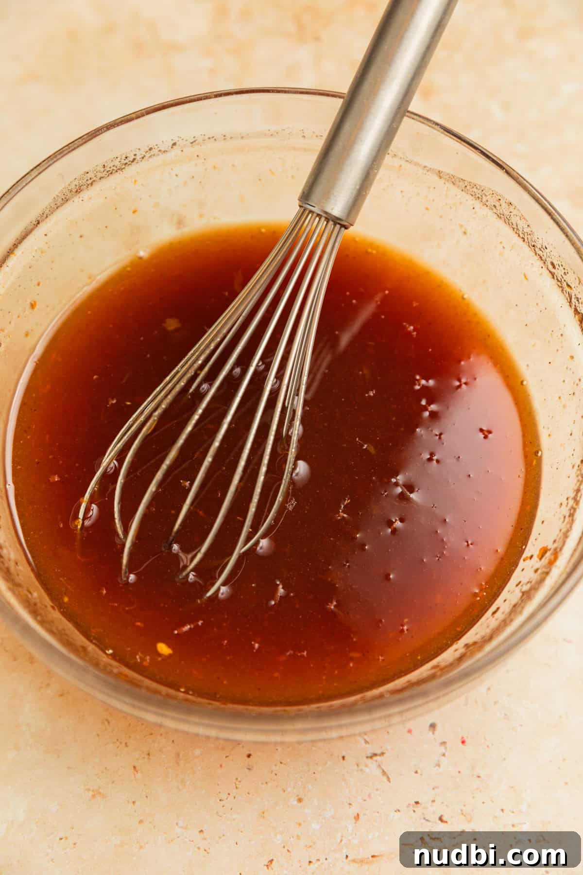 Apricot-Glazed Ham Recipe for Holidays and Entertaining 6 Apricot glaze in bowl with whisk.