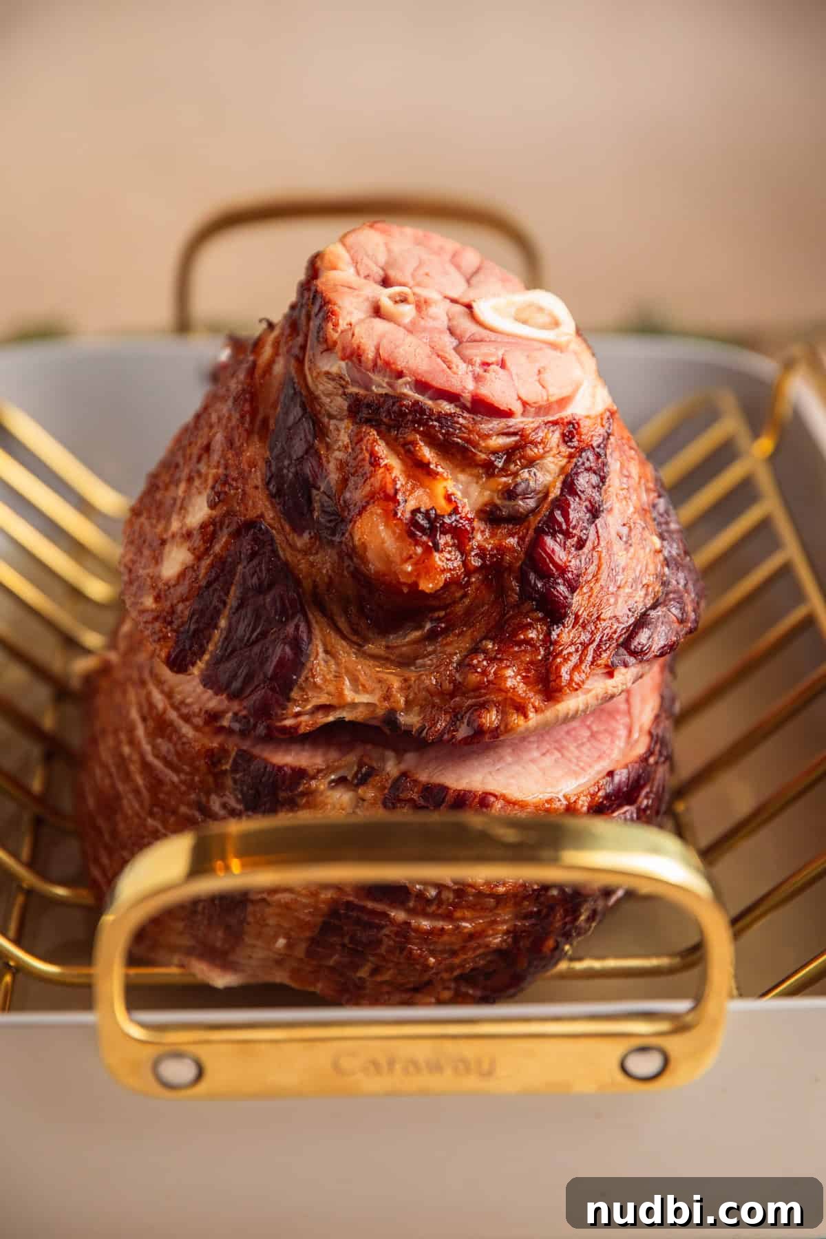 Apricot-Glazed Ham Recipe for Holidays and Entertaining 8 Roasted ham in pan with water.
