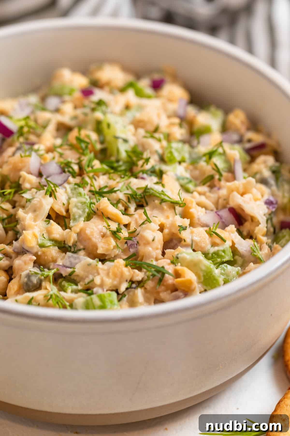Vegan Chickpea Tuna Salad Recipe — Creamy Plant-Based Lunch 2 Vegan chickpea tuna salad in clay bowl topped with chopped dill.