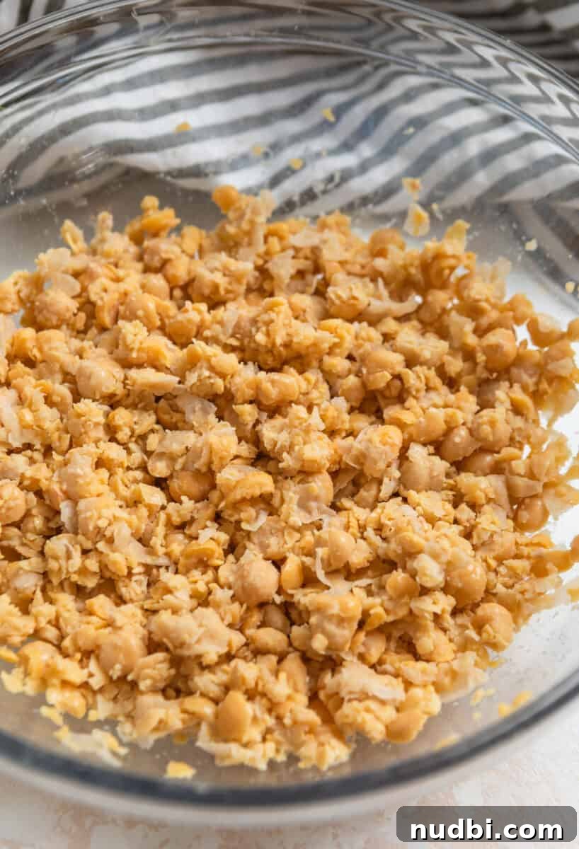 Vegan Chickpea Tuna Salad Recipe — Creamy Plant-Based Lunch 5 Chickpeas mashed in glass mixing bowl,
