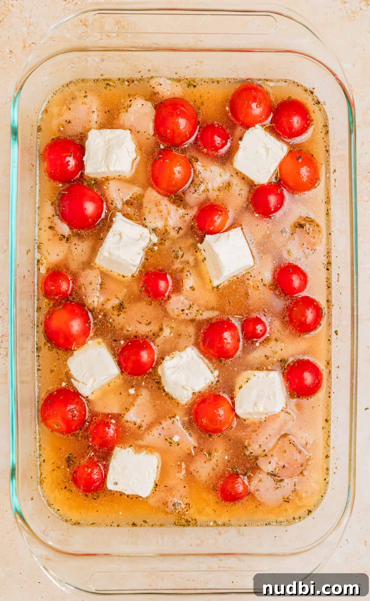 Creamy Baked Chicken and Orzo Casserole for Weeknight Dinners 7 Cream cheese cubed and placed in various spots in pan.