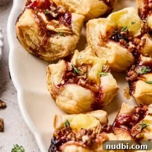 25 Must-Try Recipes Trending in 2025 17 Puff pastry brie bites on serving platter.