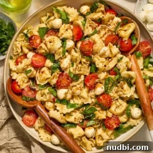 25 Must-Try Recipes Trending in 2025 22 Tortellini caprese salad in bowl topped with balsamic glaze.
