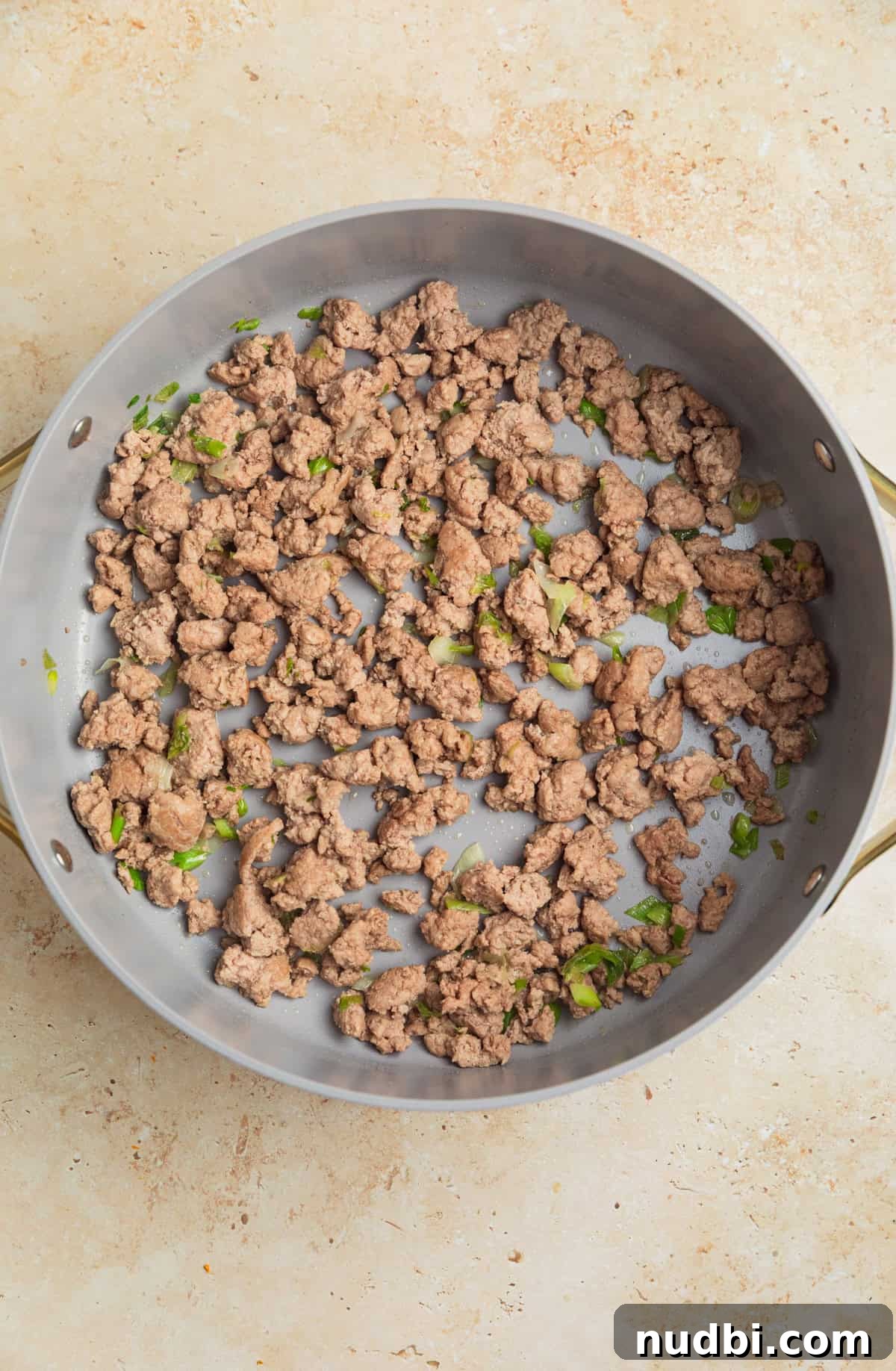 Ground Turkey Egg Roll Bowl Recipe with Asian Slaw 5 Ground turkey browned with green onions in pan.