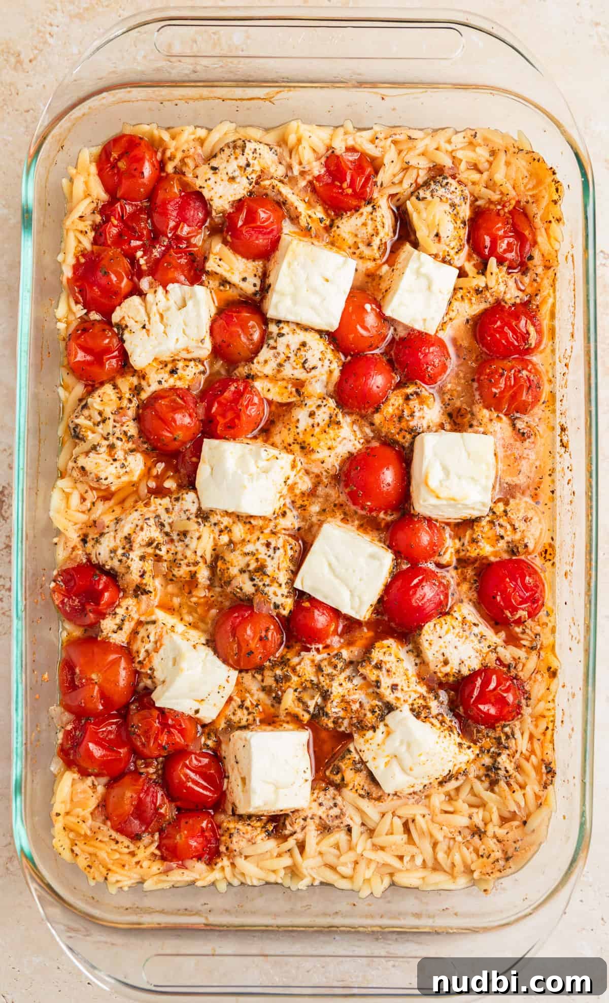Greek Chicken with Lemon Orzo Pilaf: Flavorful Mediterranean Recipe 7 Baked chicken, orzo and feta in pan.