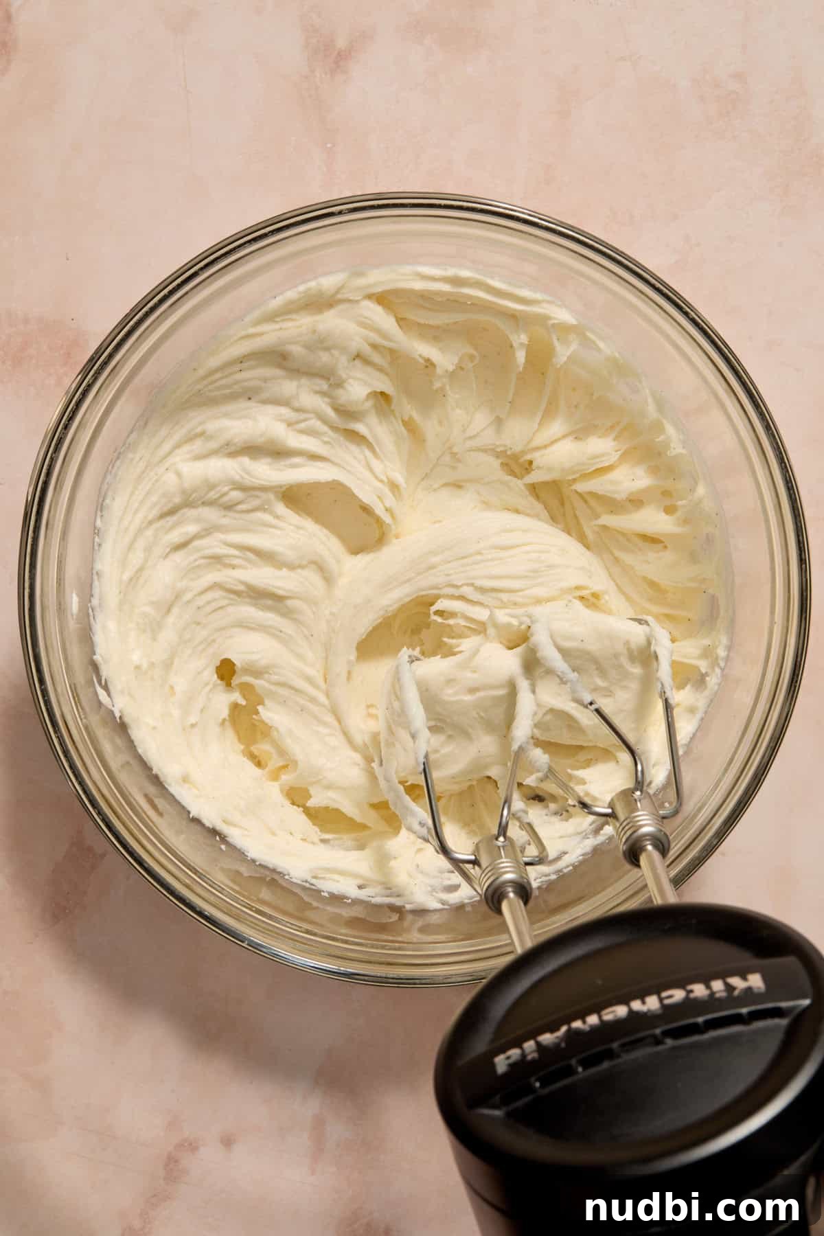 Frosted Sugar Cookie Bars Recipe — Soft, Chewy Dessert Bars 11 Vanilla bean buttercream in bowl with electric mixer.
