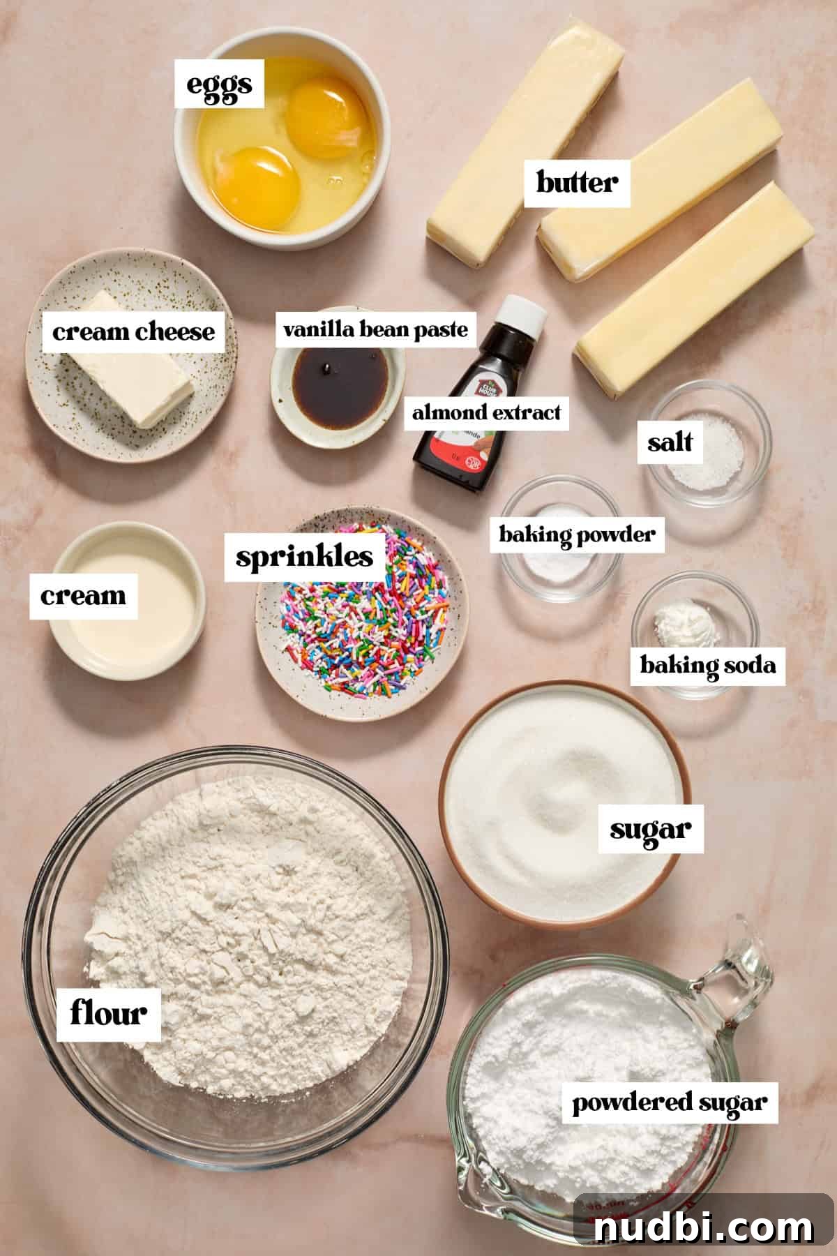 Frosted Sugar Cookie Bars Recipe — Soft, Chewy Dessert Bars 4 Butter, sugar, eggs, and other labeled ingredients on surface.