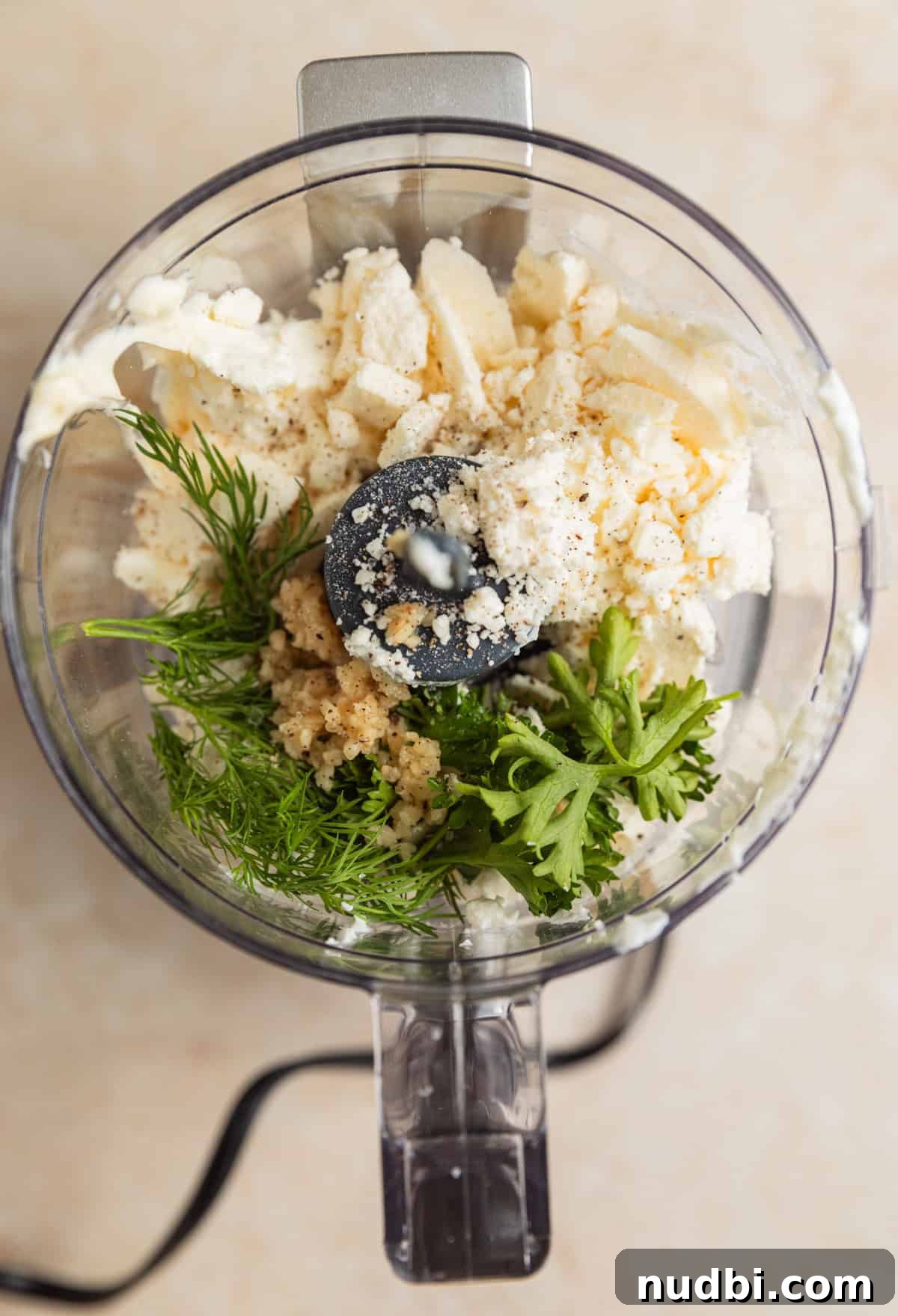 Greek-Style Sheet Pan Chicken Dinner with Lemon & Olives 9 Parsley, feta, dill, Greek yogurt, mayo and other ingredients in food processor.