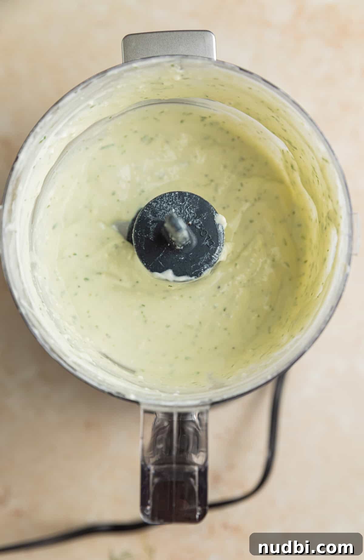 Greek-Style Sheet Pan Chicken Dinner with Lemon & Olives 10 Creamy feta yogurt sauce in food processor.