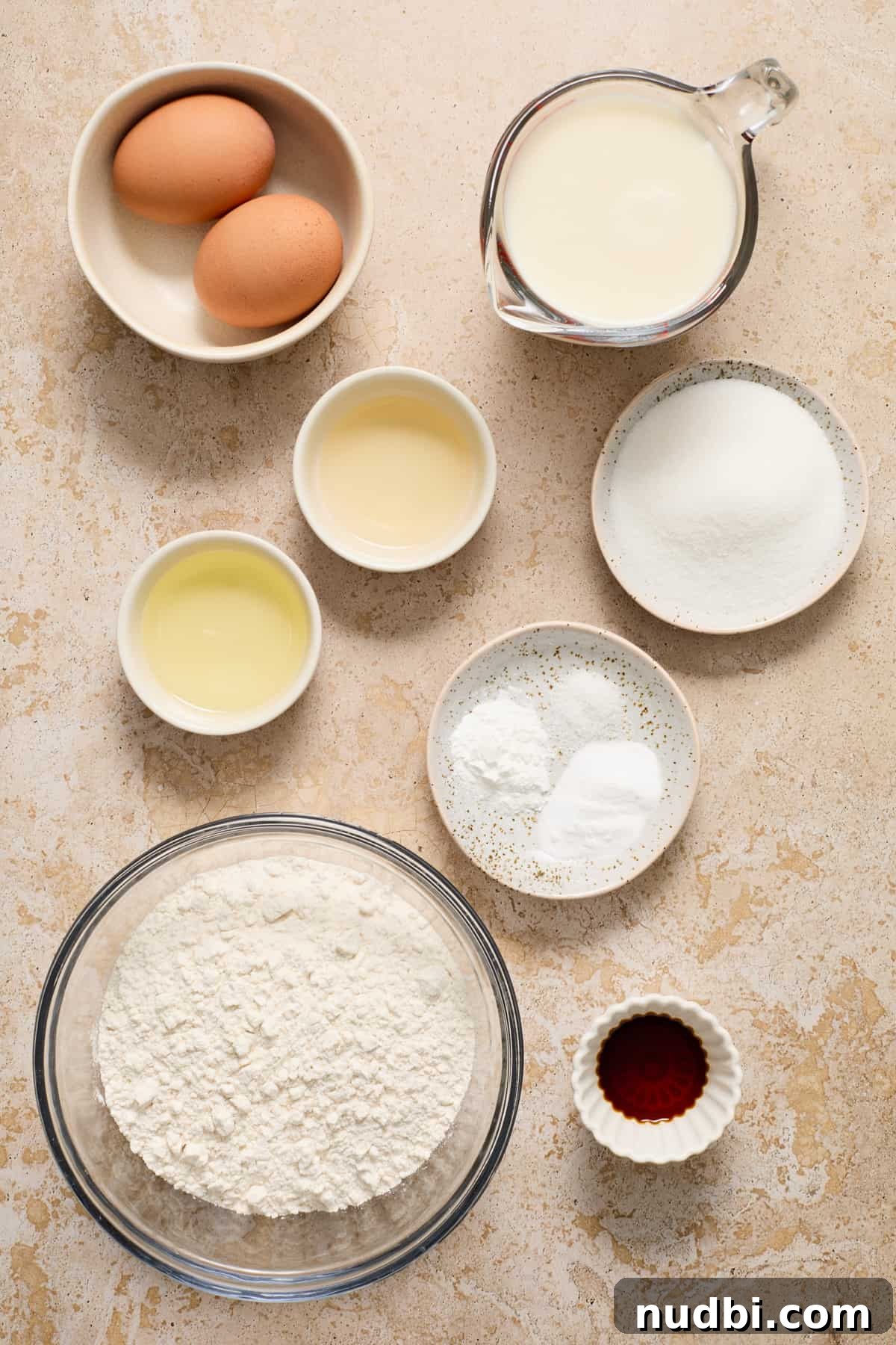 Fluffy Dairy-Free Pancakes: Simple Vegan Breakfast Recipe 3 Ingredients to make dairy free buttermilk pancakes arranged on surface.