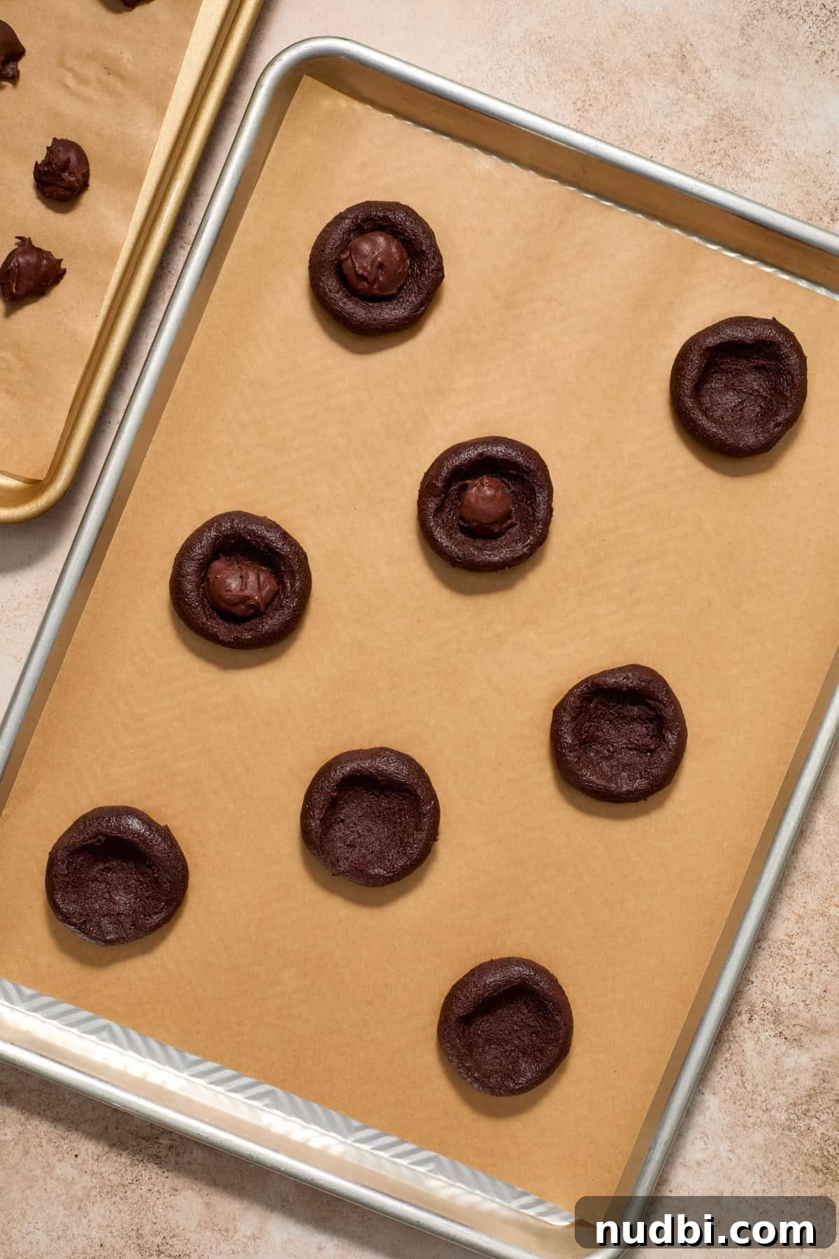 Molten Chocolate Lava Cookies Recipe: Gooey Center Cookies Tutorial 12 Cookie dough with center pressed in and chocolate ganache pieces placed in center.