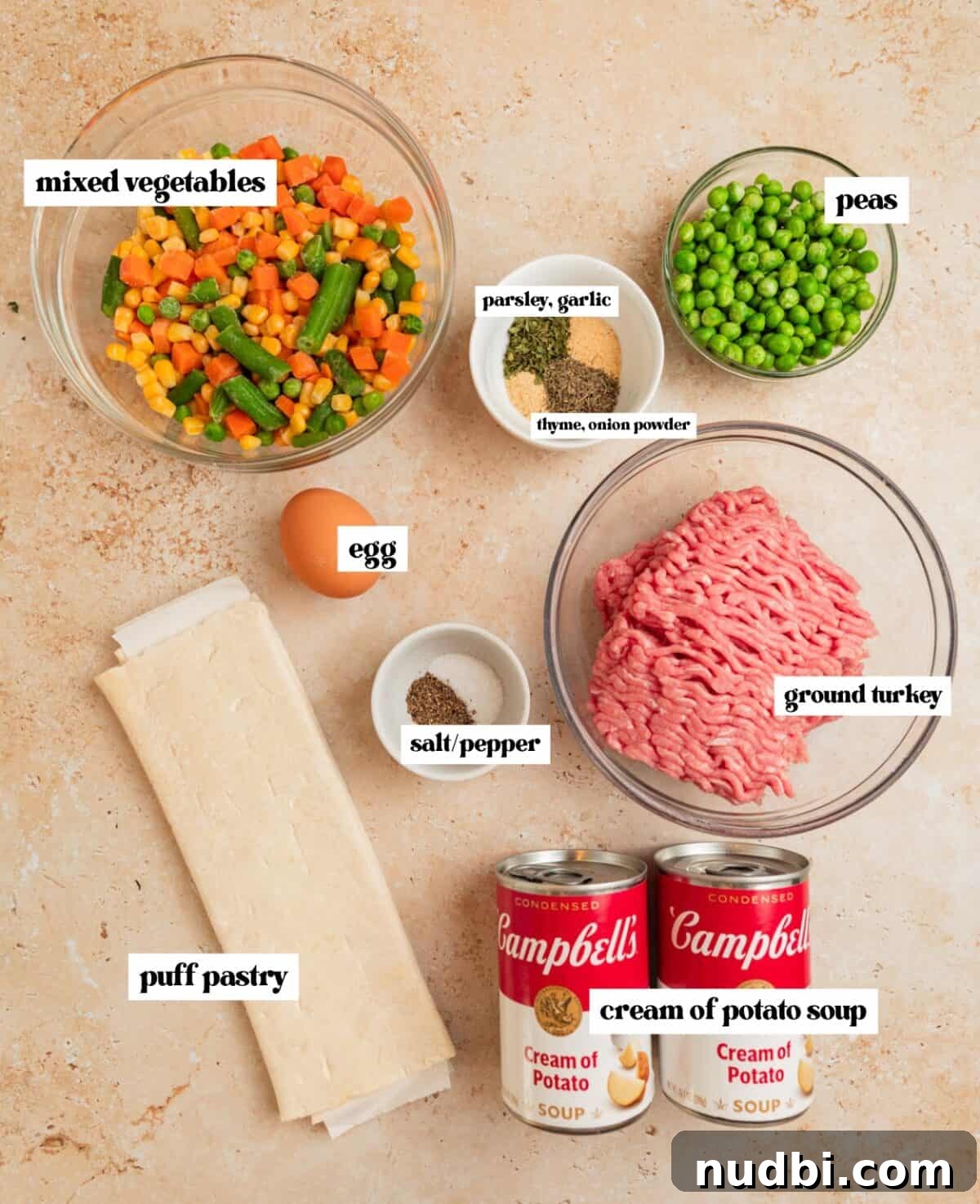 Savory Ground Turkey Pot Pie Recipe for Comforting Dinners 4 Mixed vegetables, peas, ground meat and other ingredients on surface.
