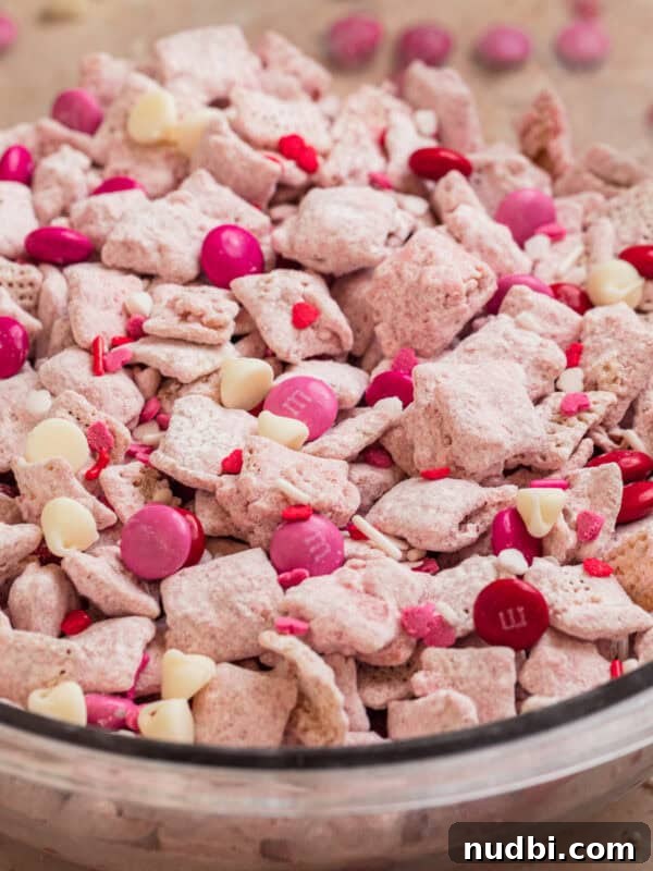 Strawberry Chex Mix Recipe: Sweet, Crunchy Snack for Parties 15 Glass bowl with strawberry puppy chow snack.