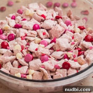 Strawberry Chex Mix Recipe: Sweet, Crunchy Snack for Parties 18 Glass bowl with strawberry puppy chow snack.