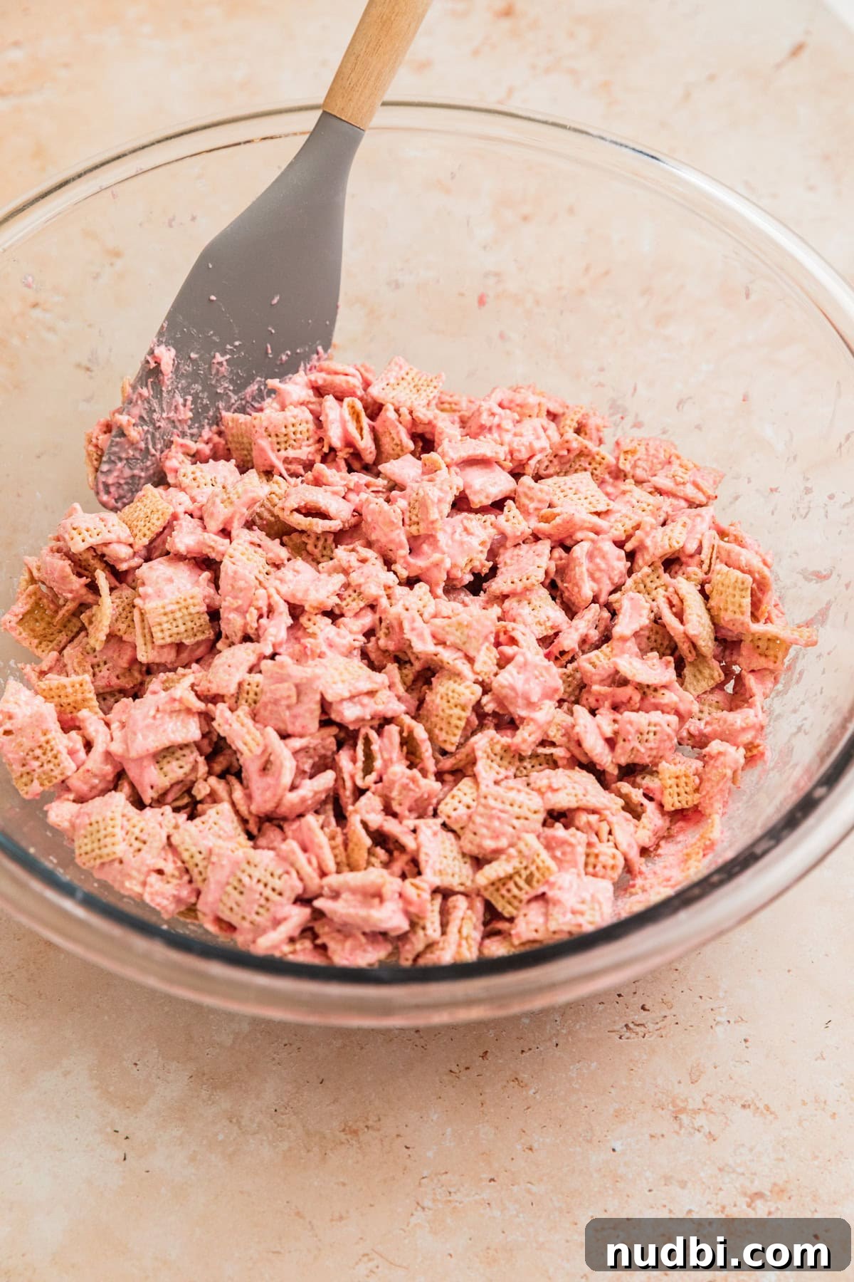 Strawberry Chex Mix Recipe: Sweet, Crunchy Snack for Parties 9 Strawberry chex mix in bowl with spoon.