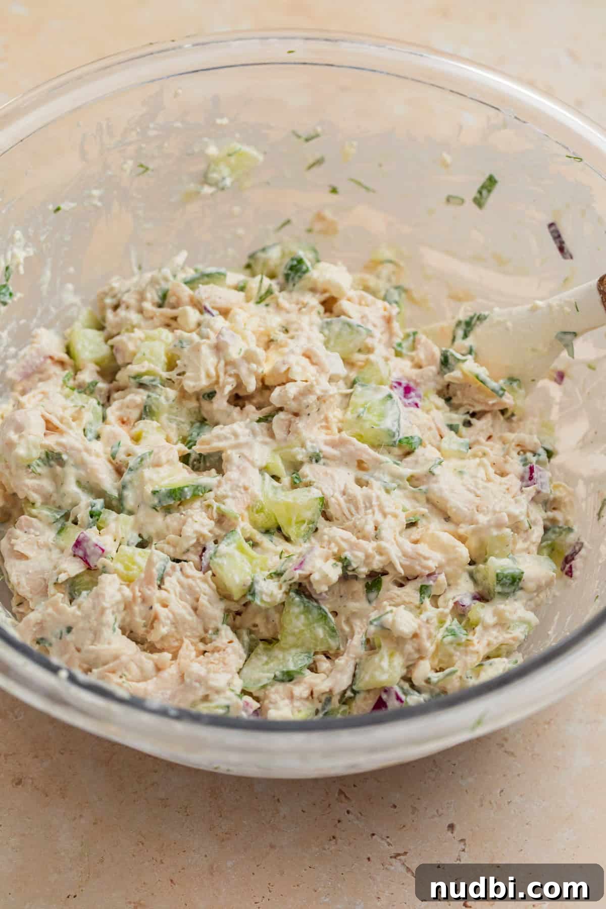 Cucumber, Feta & Chicken Salad with Lemon-Dill Dressing 6 Mixed cucumber and feta chicken salad in bowl with spatula.