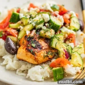 Mediterranean chicken served over rice and topped with cucumber salad.