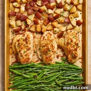 Parmesan crusted chicken sheet pan dinner cooked on baking sheet.