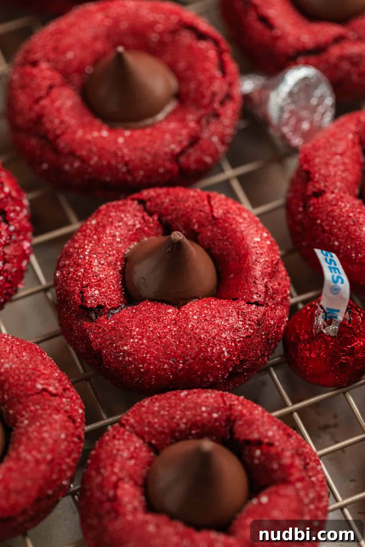 Red Velvet Blossom Cookies Recipe — Soft, Cream Cheese Frosting 2 Red velvet blossom cookies on cooling rack.
