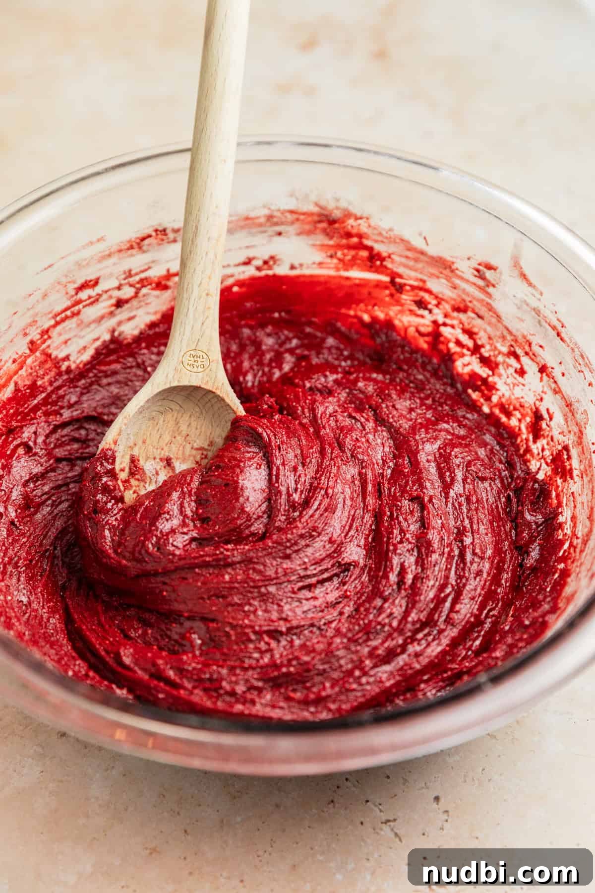 Red Velvet Blossom Cookies Recipe — Soft, Cream Cheese Frosting 7 Red velvet cake mix cookie dough in bowl with wooden spoon.