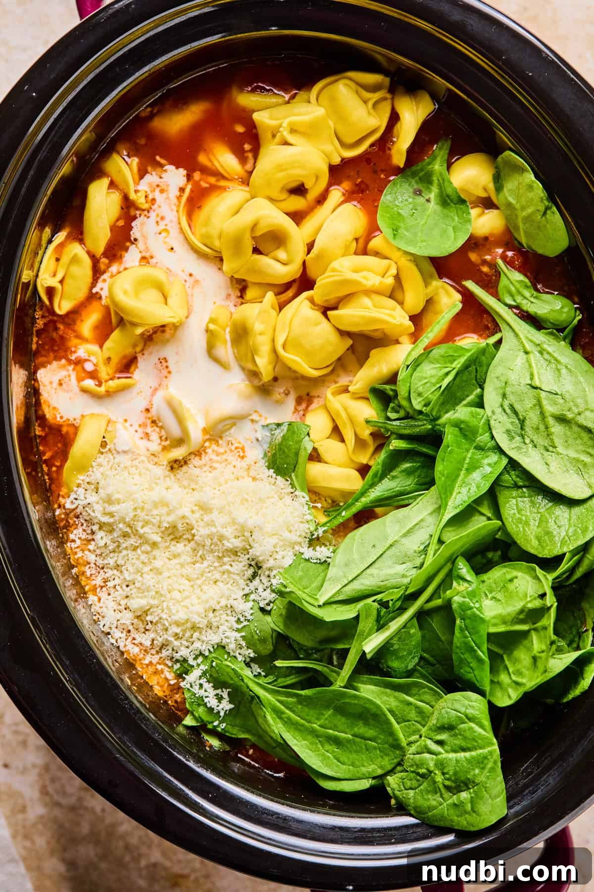 Slow-Cooker Sausage and Tortellini Soup Recipe 11 Tortellini, spinach, cream and parmesan added to soup in crockpot.
