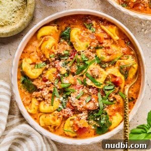 Slow-Cooker Sausage and Tortellini Soup Recipe 18 Crockpot sausage and tortellini soup in bowl with spoon.