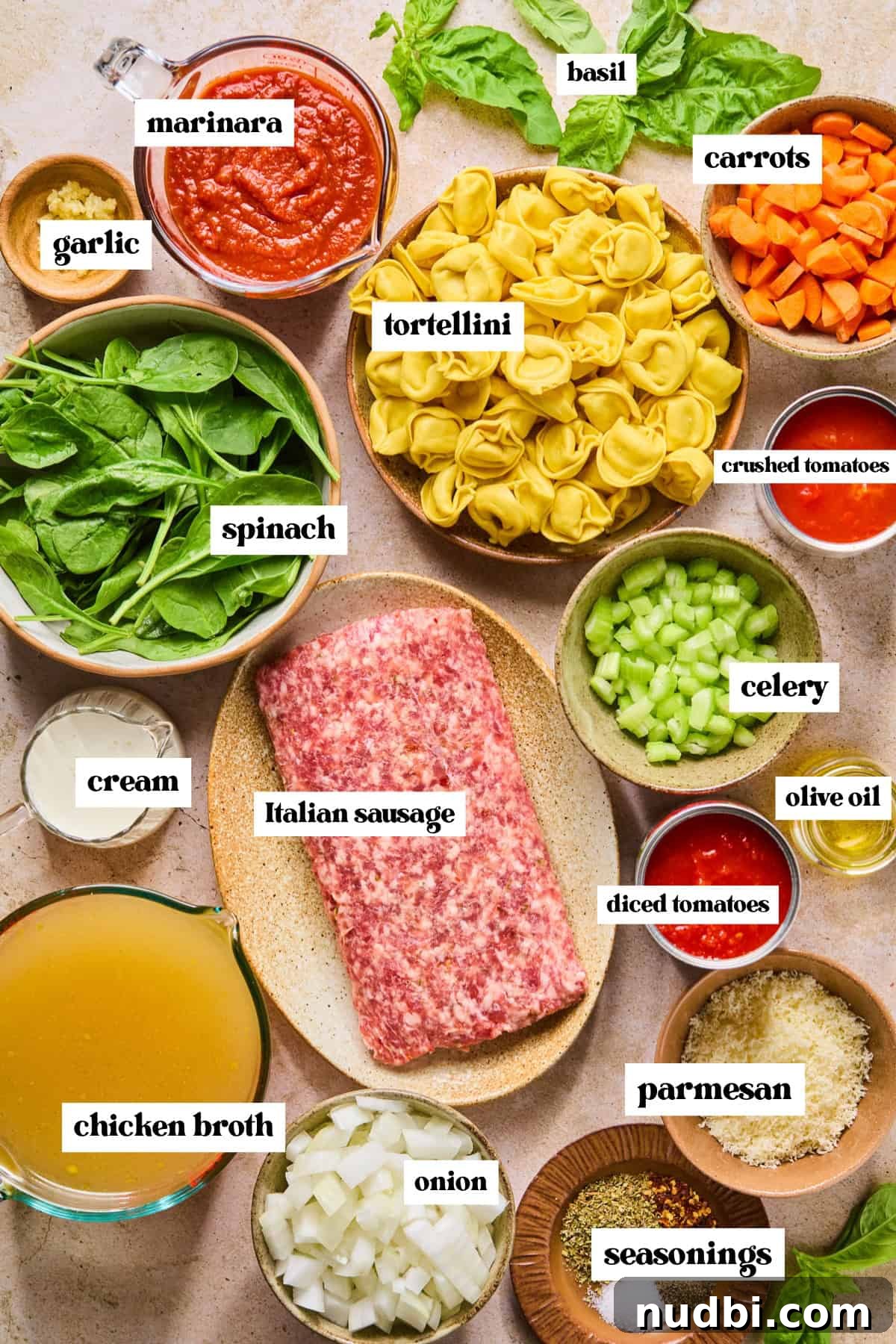 Slow-Cooker Sausage and Tortellini Soup Recipe 4 Chopped carrots and celery, spinach, cream, meat, tomatoes and other labeled ingredients.