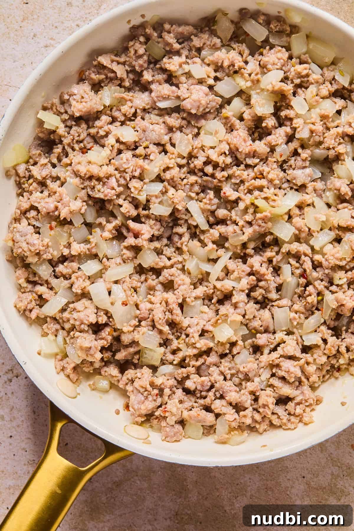 Slow-Cooker Sausage and Tortellini Soup Recipe 6 Browned Italian sausage in skillet with onions.