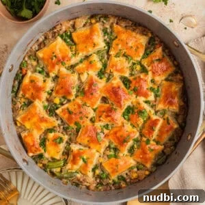 Ground turkey pot pie in pan with pieces of puff pastry over top.