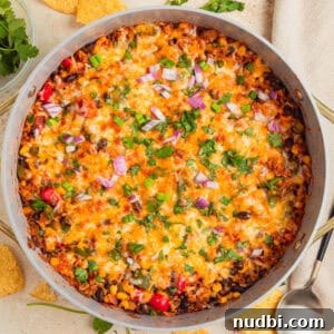 Cheesy taco and rice skillet dinner in pan.