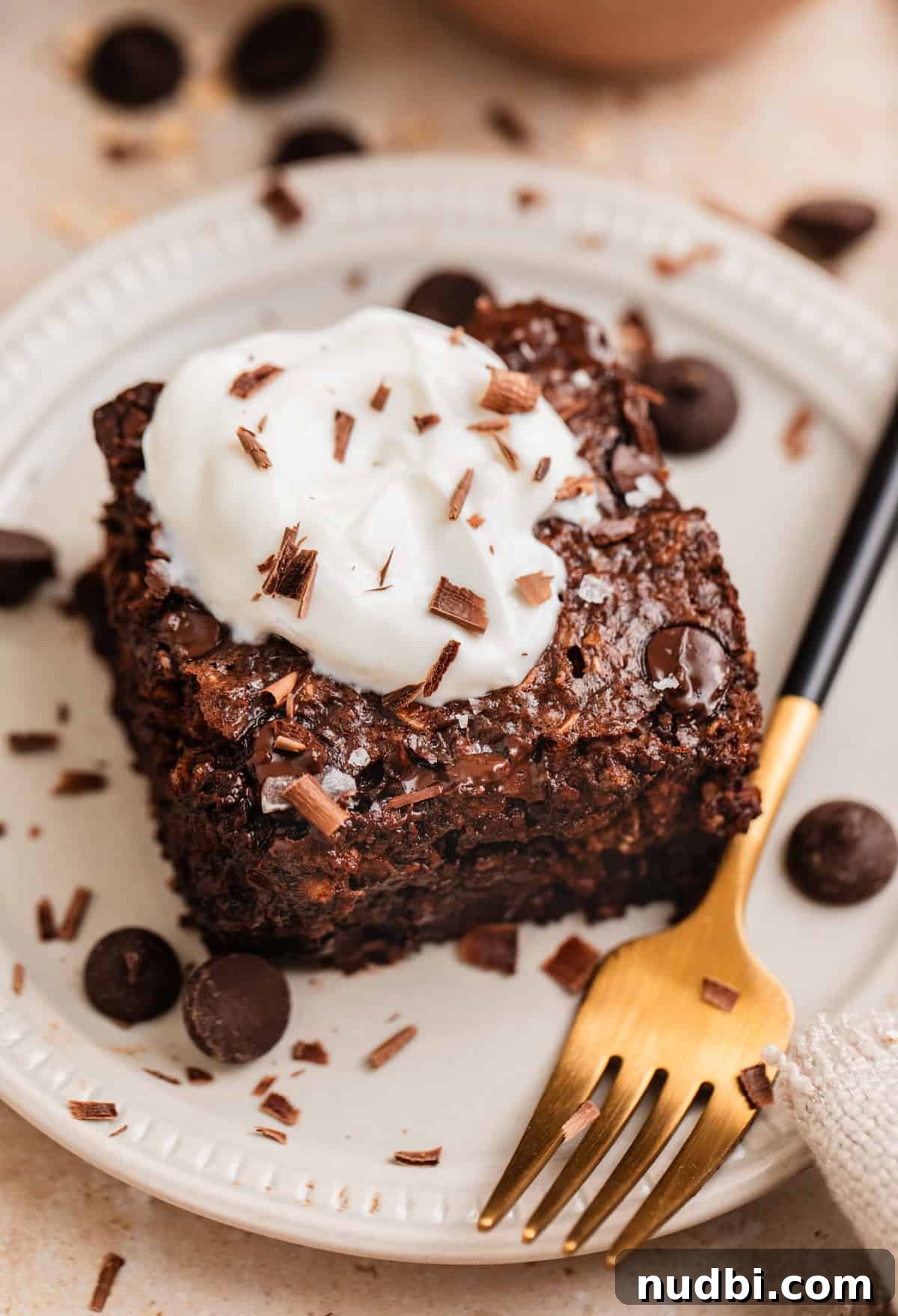 Decadent Chocolate Baked Oats Recipe for Breakfast and Snacks 2 Slice of chocolate baked oats with Greek yogurt on top.