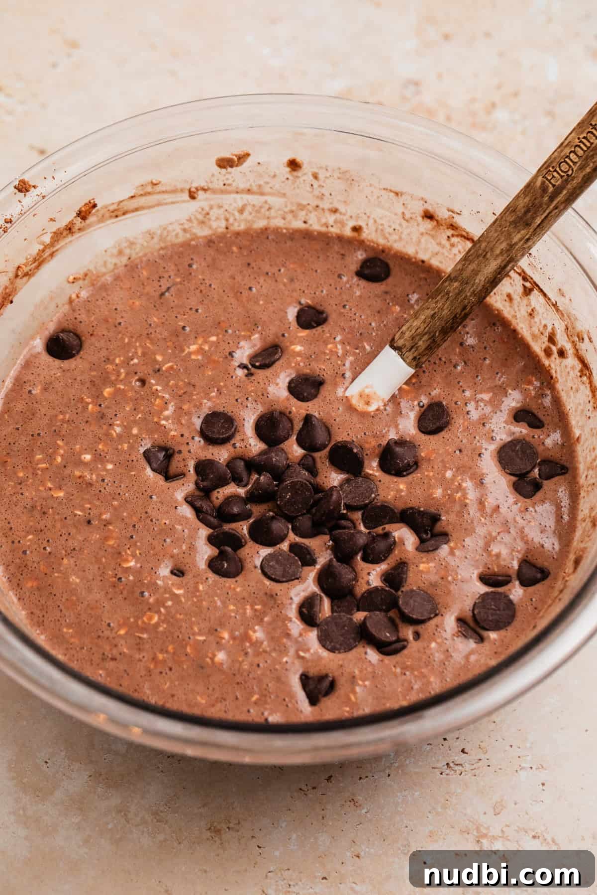 Decadent Chocolate Baked Oats Recipe for Breakfast and Snacks 6 Chocolate chips added to bowl with chocolate oats.