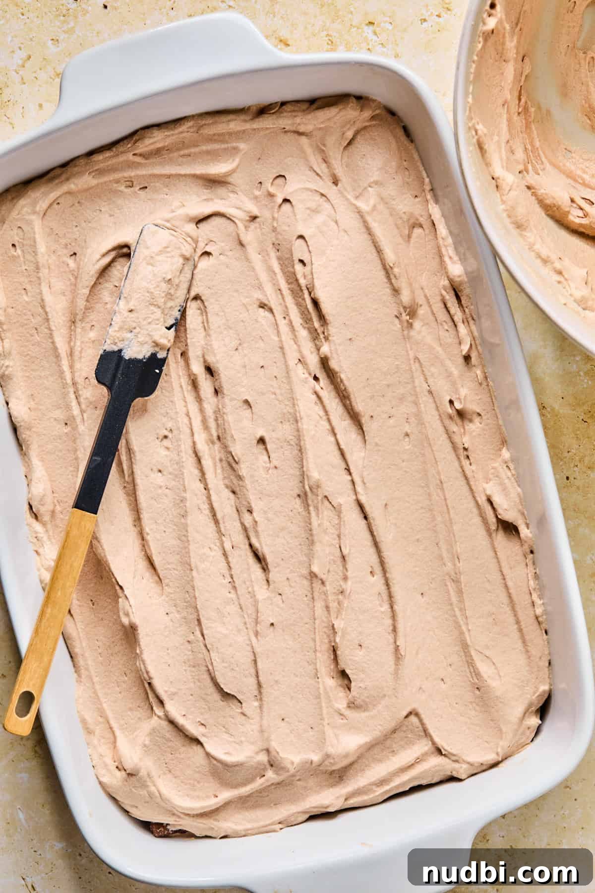 Decadent No-Bake Chocolate Icebox Cake Recipe 14 Chocolate whipped cream spread over top of grahams in pan.