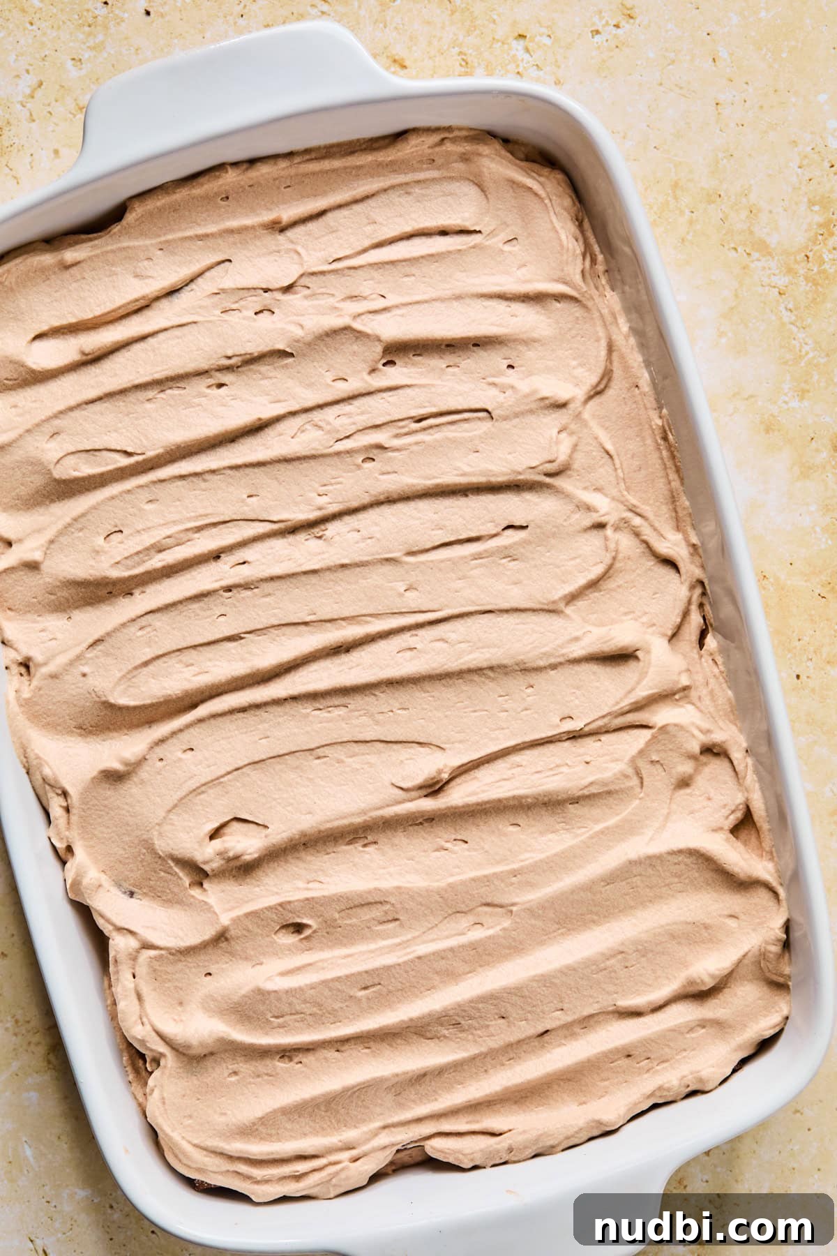 Decadent No-Bake Chocolate Icebox Cake Recipe 16 Hot chocolate icebox cake with chocolate whipped cream spread over top.