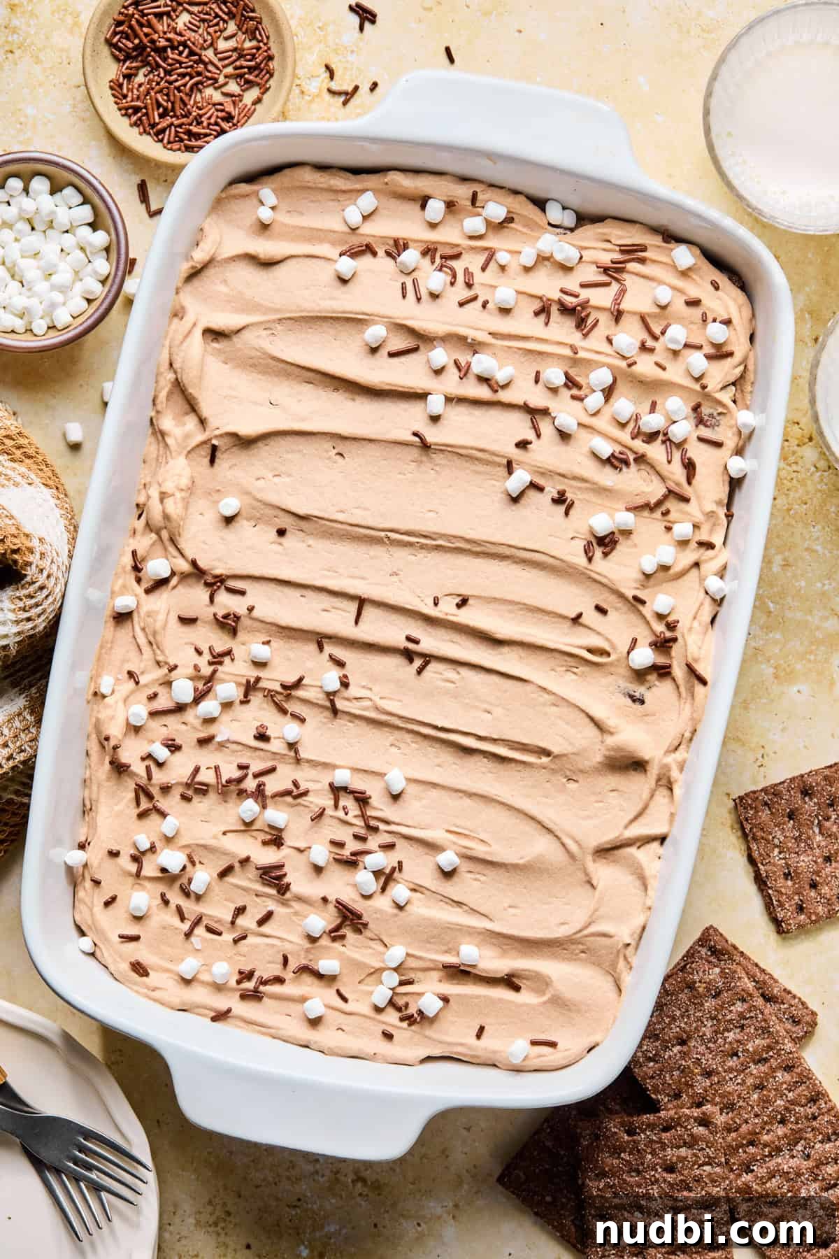 Decadent No-Bake Chocolate Icebox Cake Recipe 17 Hot cocoa icebox cake topped with mini marshmallows and chocolate sprinkles .