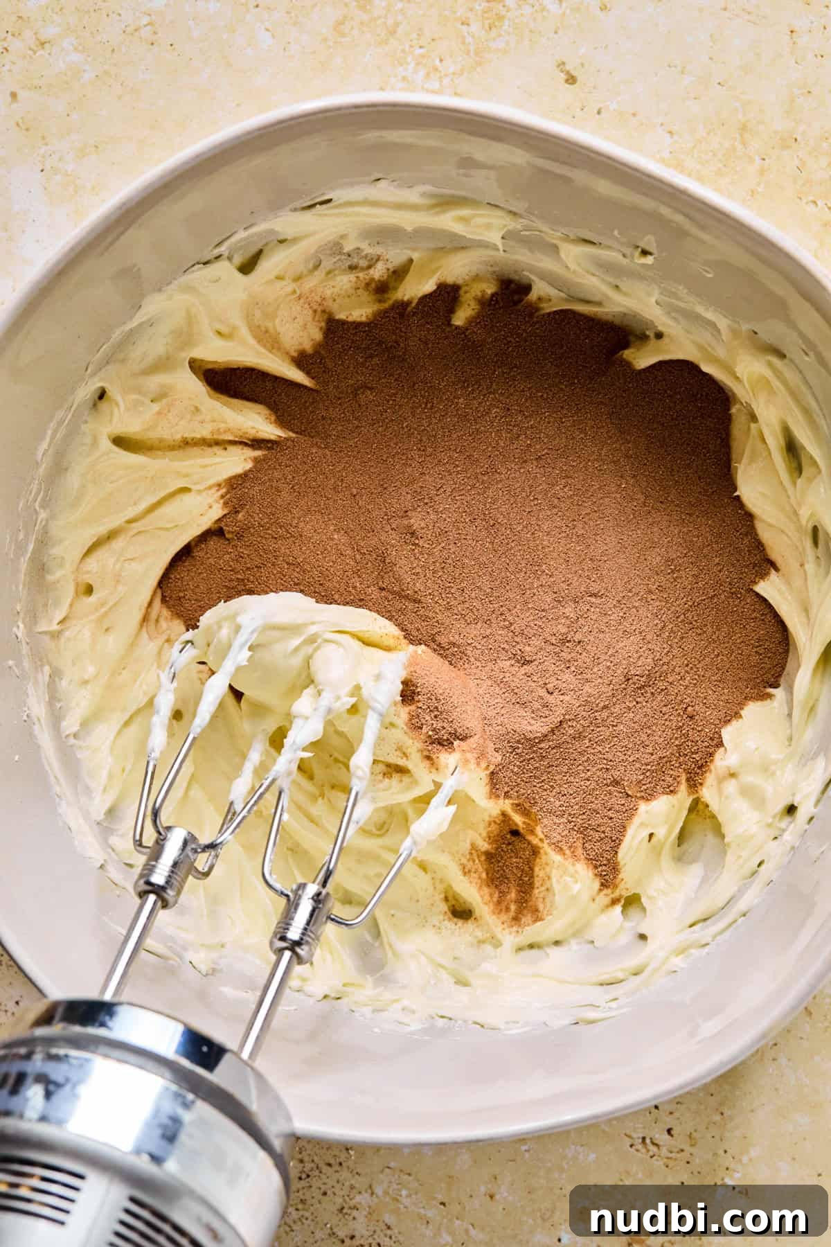 Decadent No-Bake Chocolate Icebox Cake Recipe 7 Cream cheese mixture in bowl with hot cocoa added.