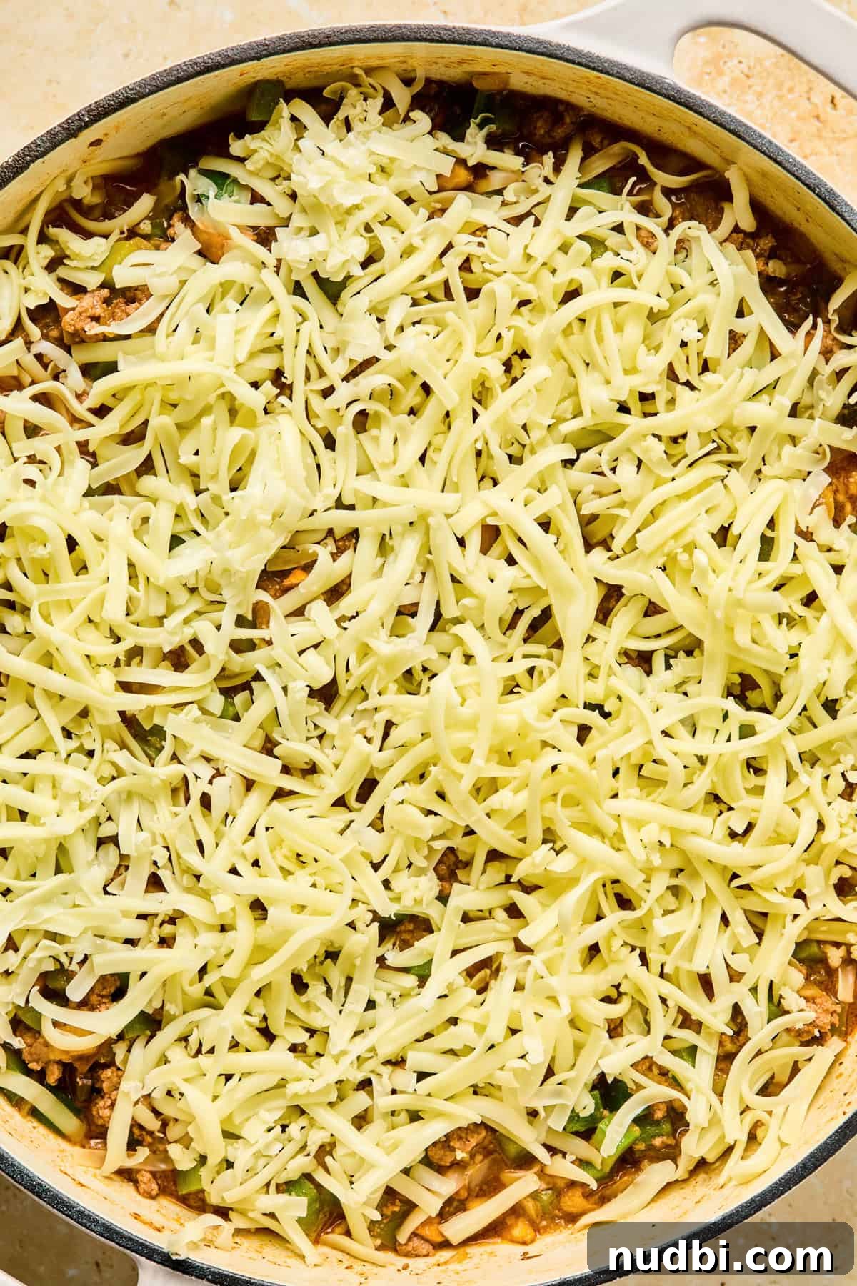 Philly Cheesesteak Rice Bowl Recipe — Savory Steak & Peppers 11 Shredded mozzarella cheese covering top of Philly cheesesteak skillet.
