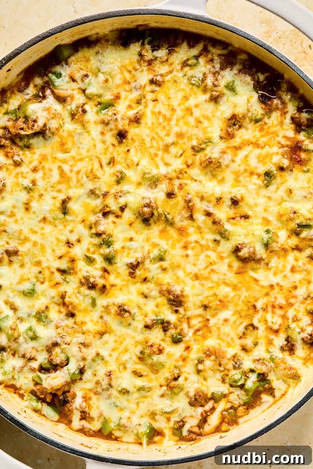 Philly Cheesesteak Rice Bowl Recipe — Savory Steak & Peppers 12 Melted mozzarella cheese over top of Philly Cheesesteak skillet for rice bowls.