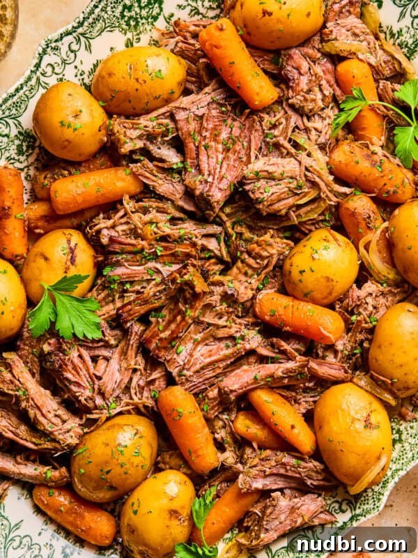 Philly Cheesesteak Rice Bowl Recipe — Savory Steak & Peppers 14 Plate with pot roast served with meat, potatoes and carrots and chopped parsley on top.