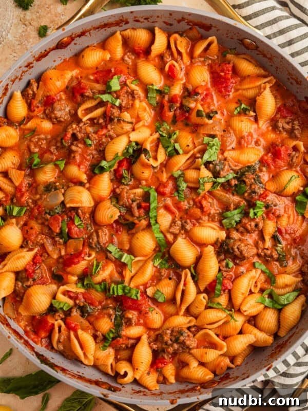 Philly Cheesesteak Rice Bowl Recipe — Savory Steak & Peppers 15 Ground beef pasta in skillet topped with basil.