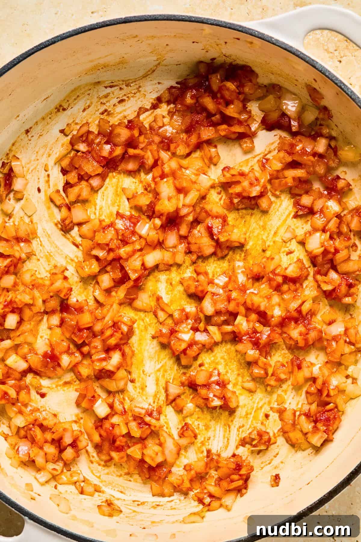 Philly Cheesesteak Rice Bowl Recipe — Savory Steak & Peppers 7 Tomato paste and onion in pan.