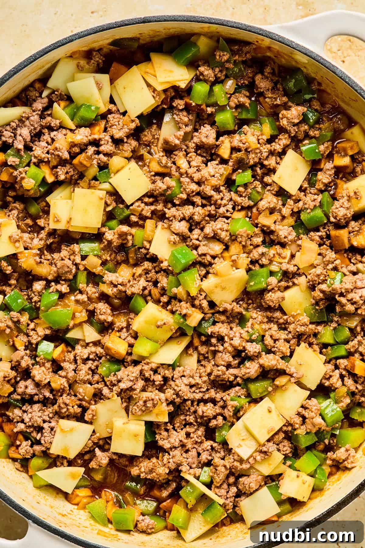 Philly Cheesesteak Rice Bowl Recipe — Savory Steak & Peppers 10 Ground beef stirred back into skillet with chopped provolone cheese pieces.
