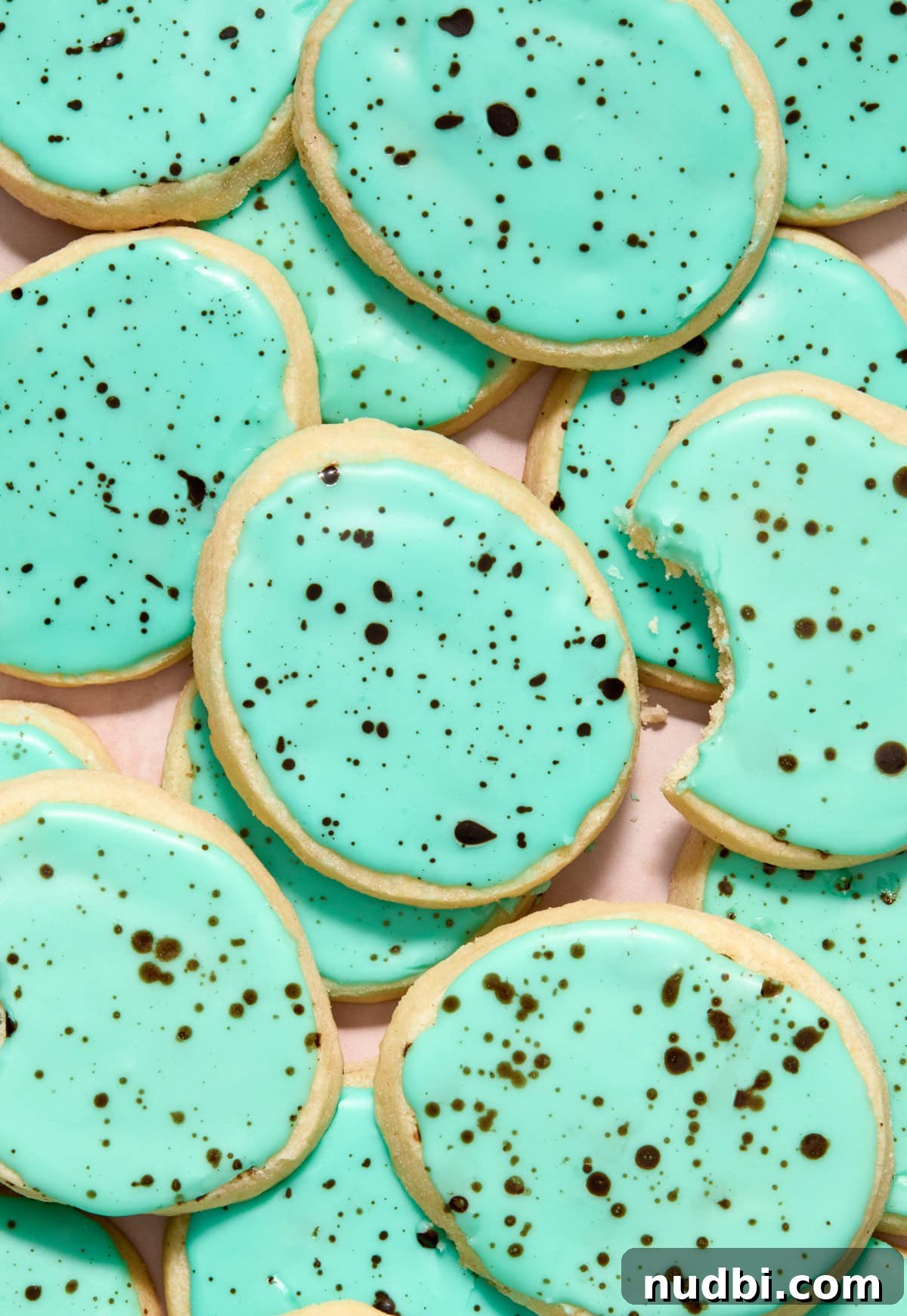 Speckled Easter Egg Shortbread Cookies Recipe 2 Speckled robin egg Easter egg shortbread cookies on surface.
