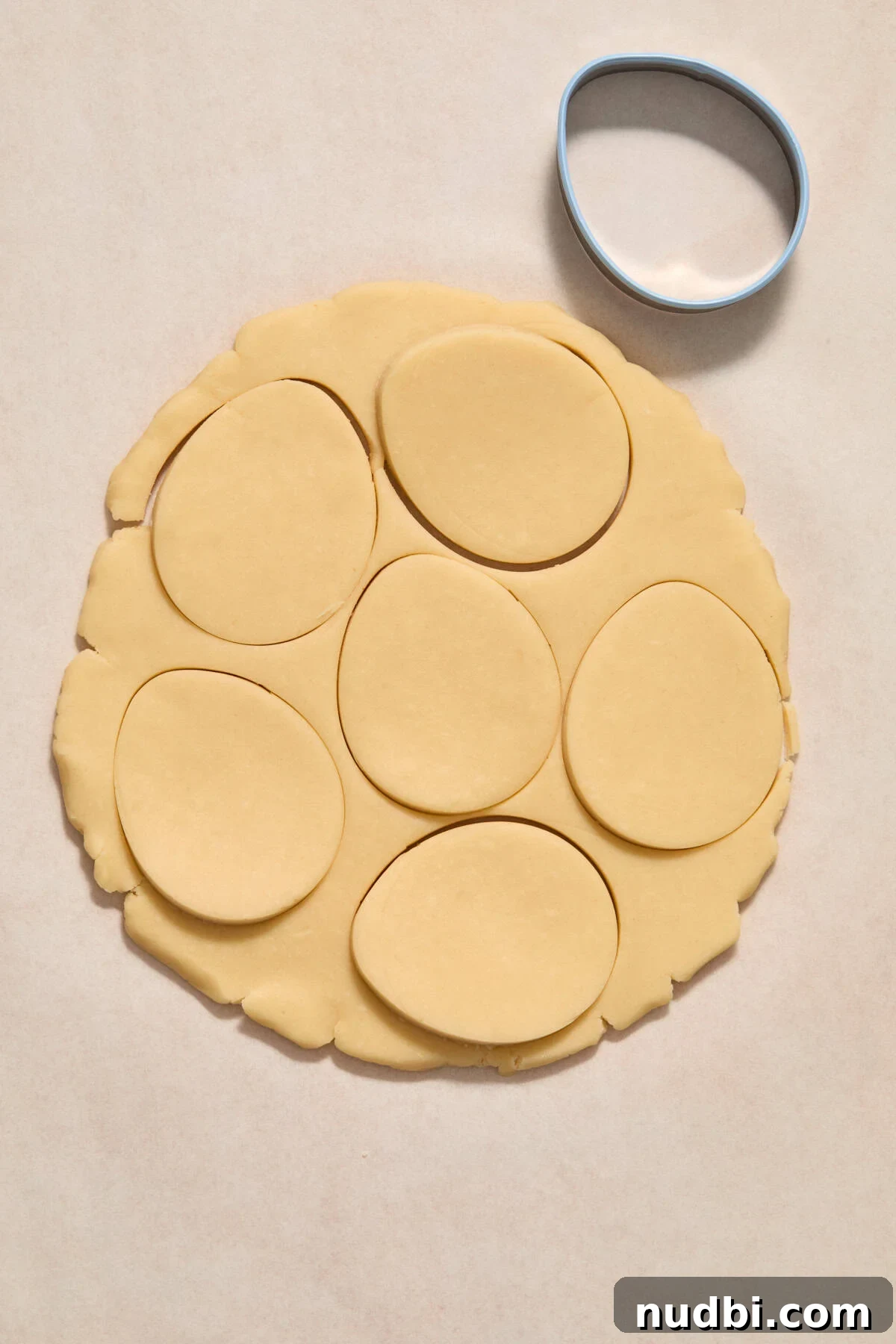 Speckled Easter Egg Shortbread Cookies Recipe 9 Cookie dough rolled out with egg cookie cutter pressed into it.