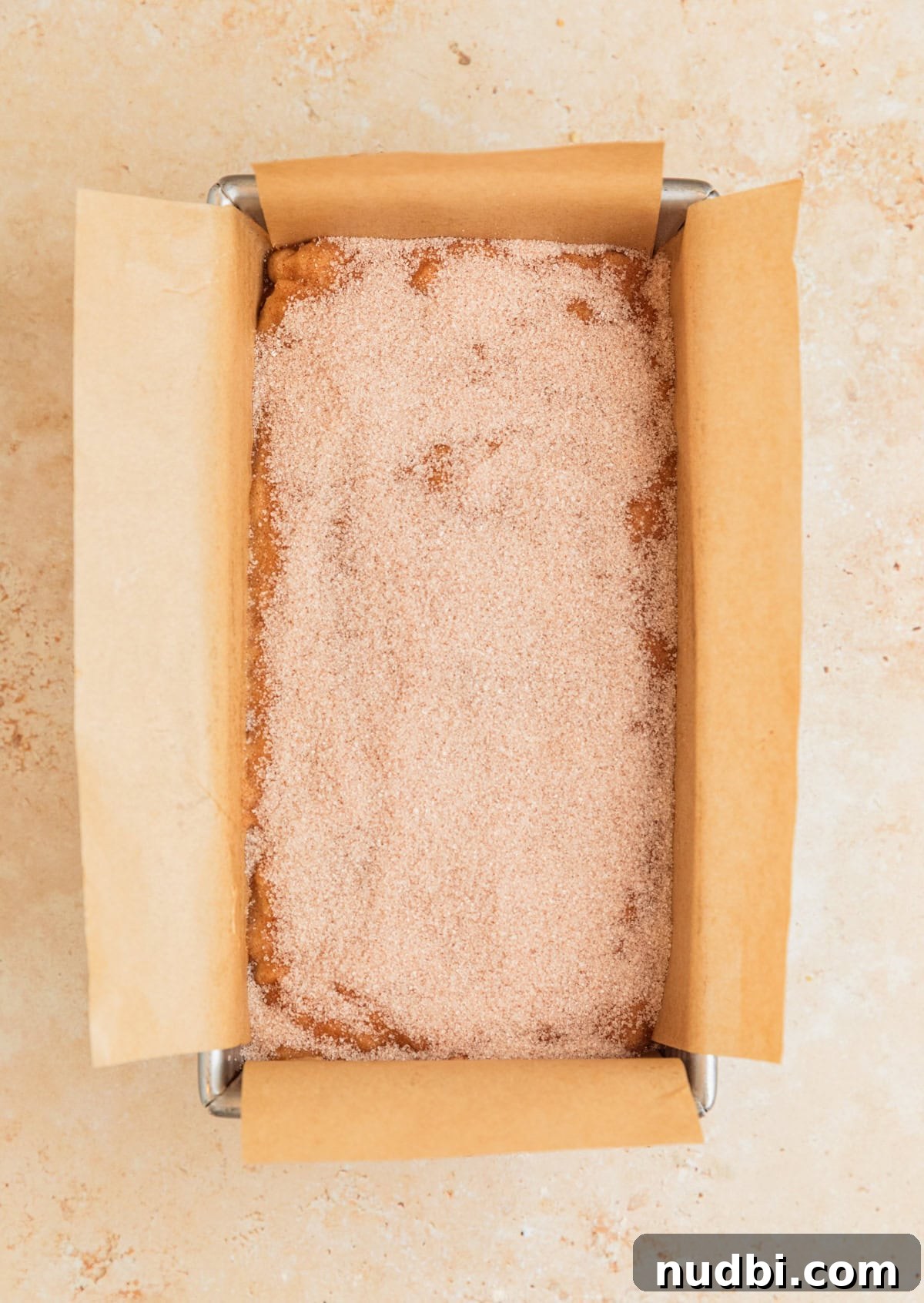 Moist Cinnamon Banana Bread Recipe with Warm Spice Flavor 11 Cinnamon sugar topping poured over banana bread before baking.