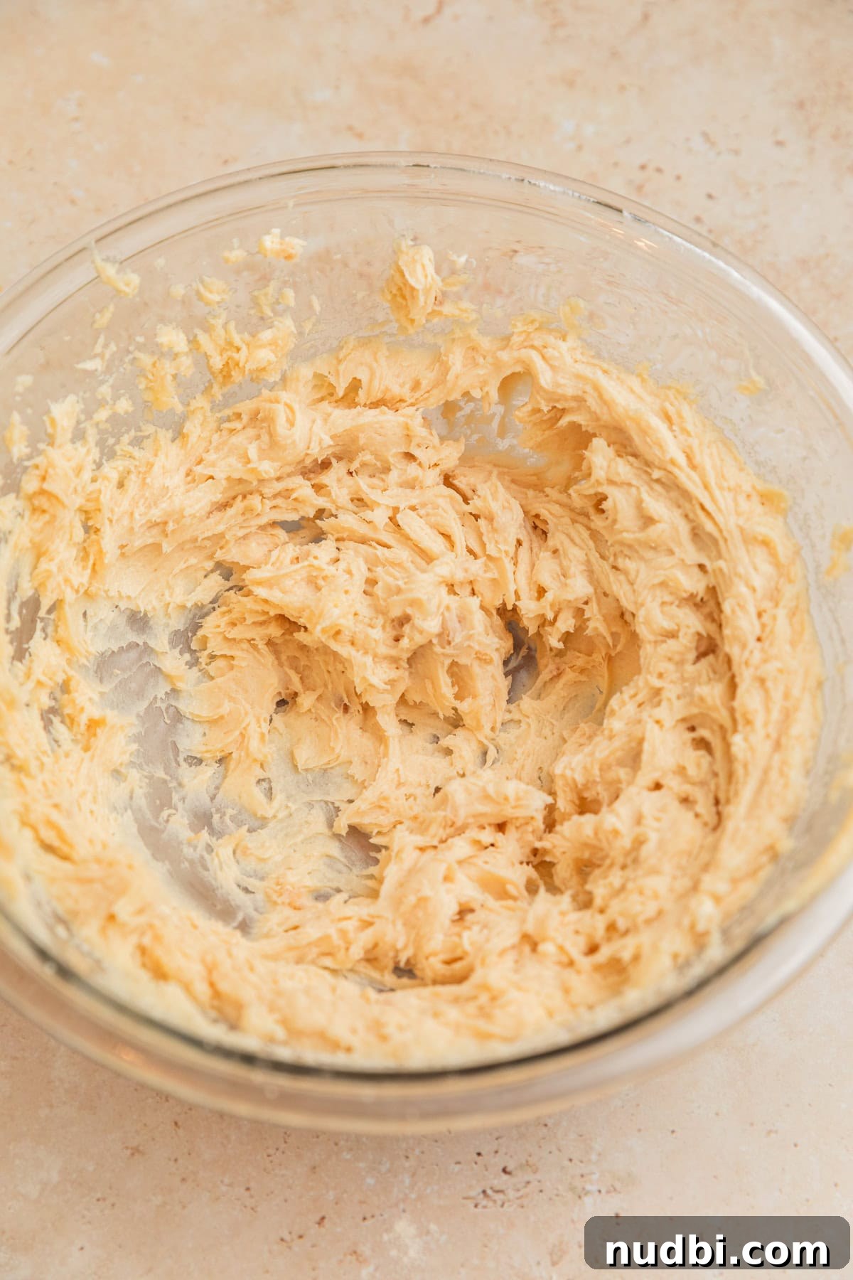 Moist Cinnamon Banana Bread Recipe with Warm Spice Flavor 6 Creamed butter, sugars and cream cheese in glass mixing bowl.