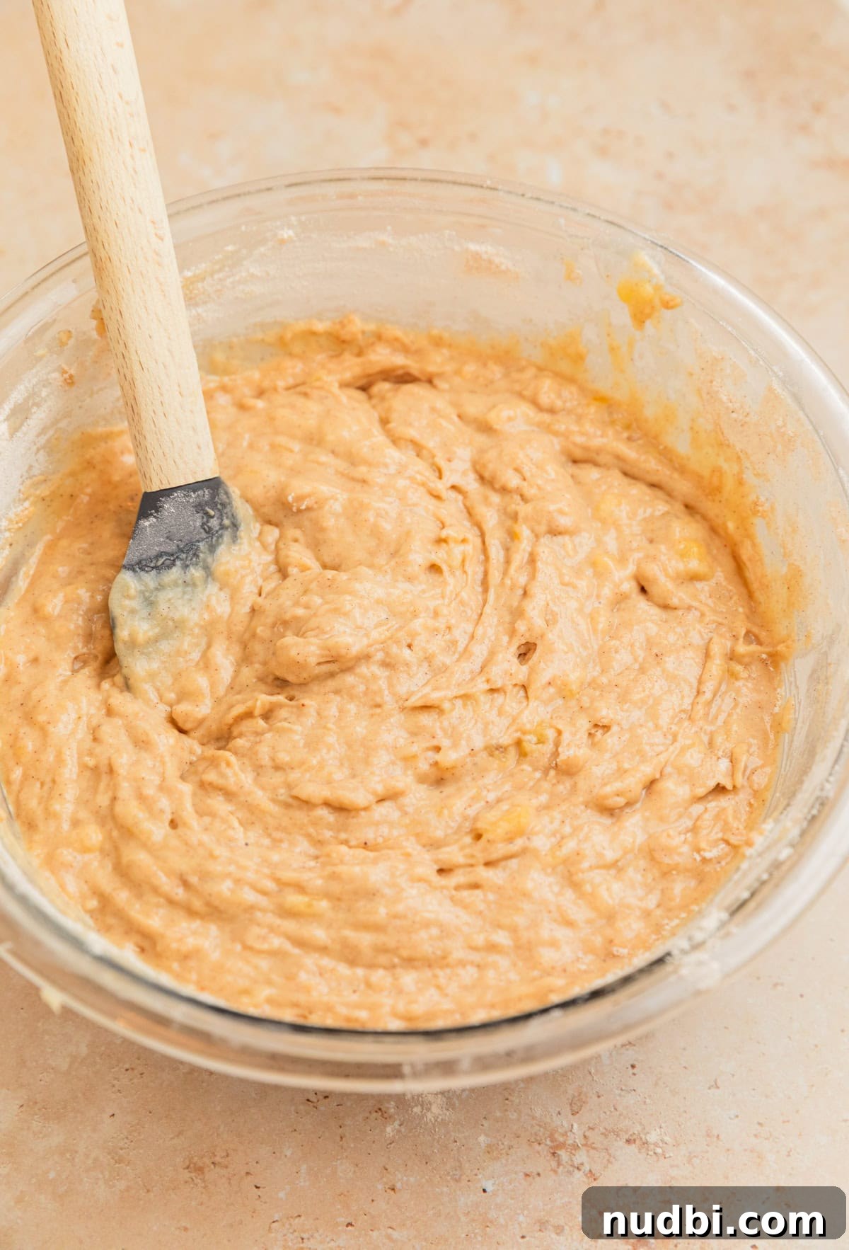Moist Cinnamon Banana Bread Recipe with Warm Spice Flavor 9 Cinnamon banana bread mixture in bowl with spatula.