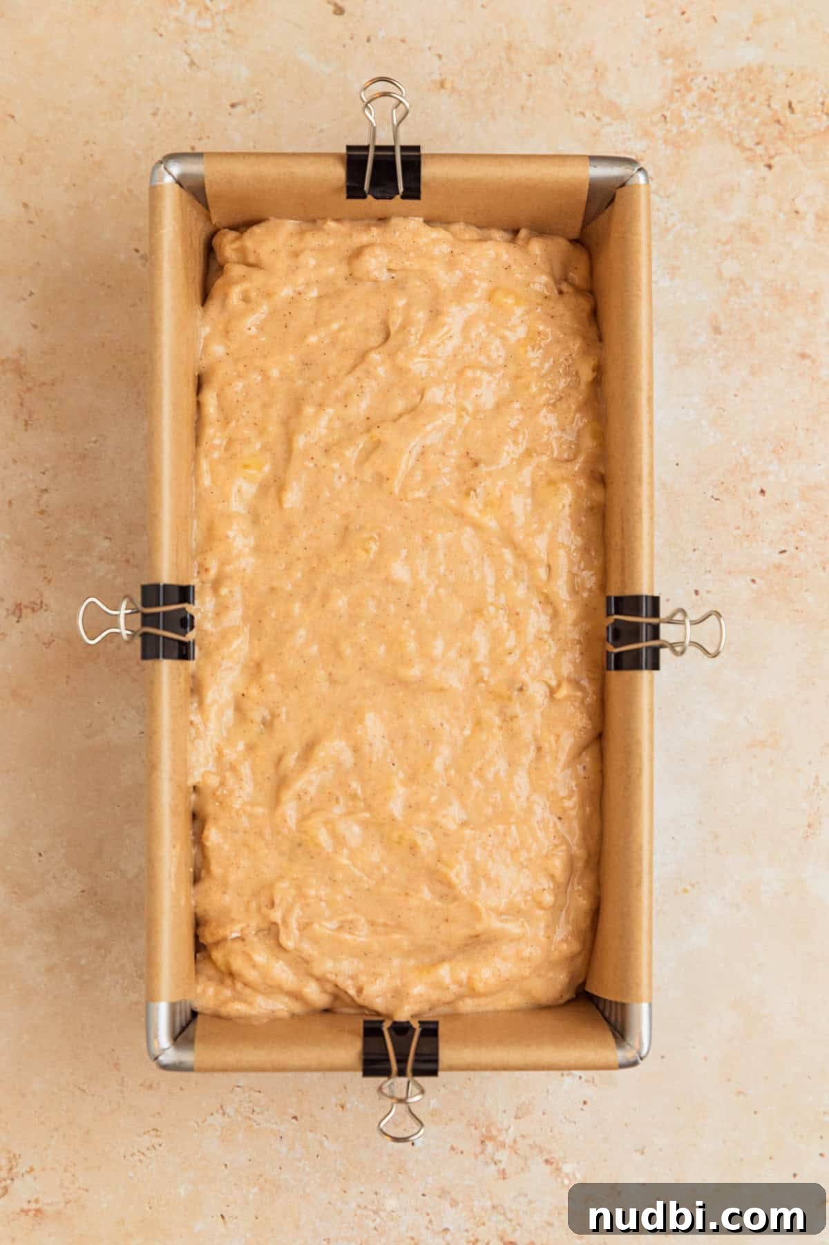 Moist Cinnamon Banana Bread Recipe with Warm Spice Flavor 10 Banana bread batter in parchment lined bread pan.