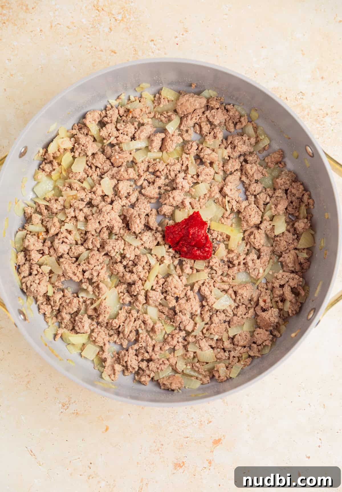 One-Pot Ground Turkey Pasta Dinner Recipe 6 Browned ground turkey in pan with tomato paste added.